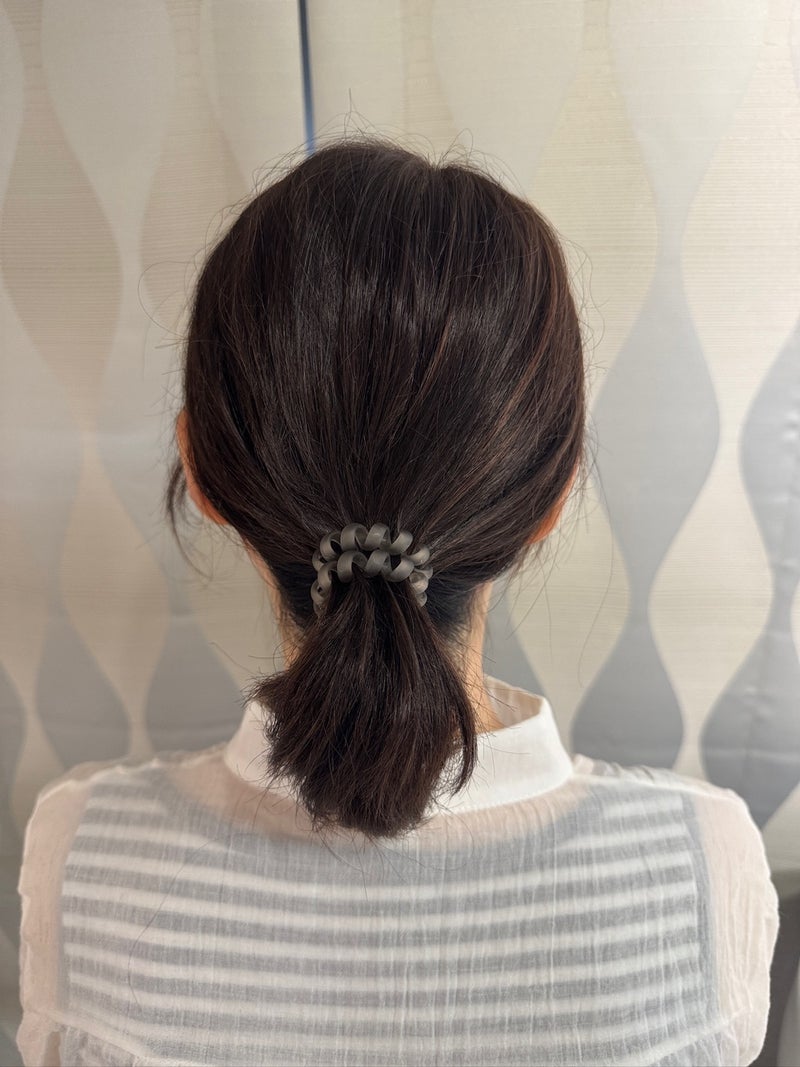 ヘアゴムで低い位置にまとめたポニーテールの後ろ姿